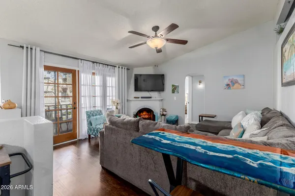 a living room with furniture and wooden floor