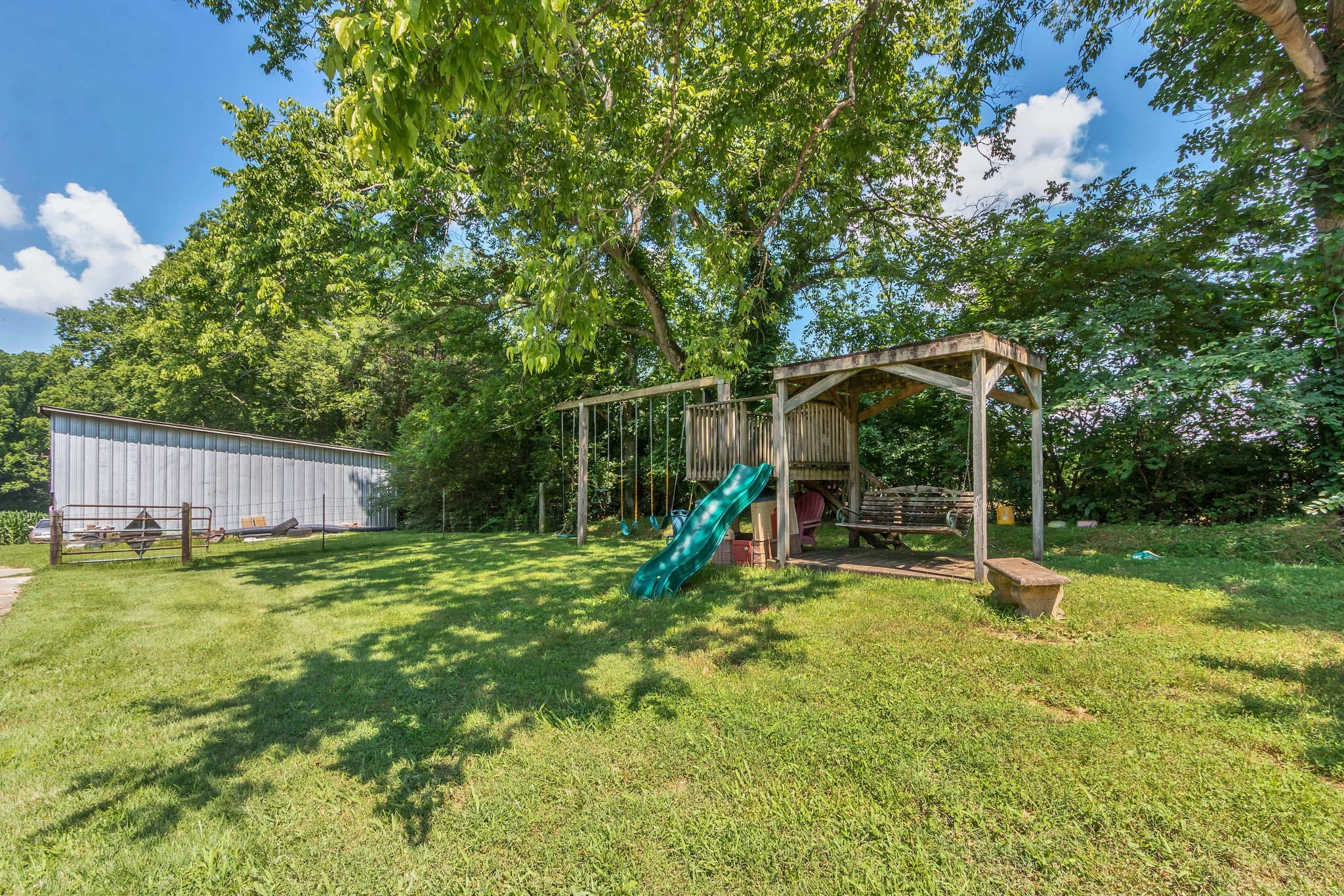 3349 Sweeney Hollow Road Franklin, TN 37064 - Photo 19 of 41 a backyard of a house with childrens swings and slides