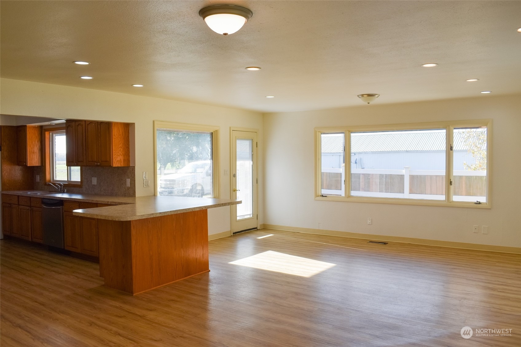 2287 Slater Road Ferndale, WA 98248 - Photo 4 of 19 a large kitchen with stainless steel appliances granite countertop a large counter top a wooden floors and a large window
