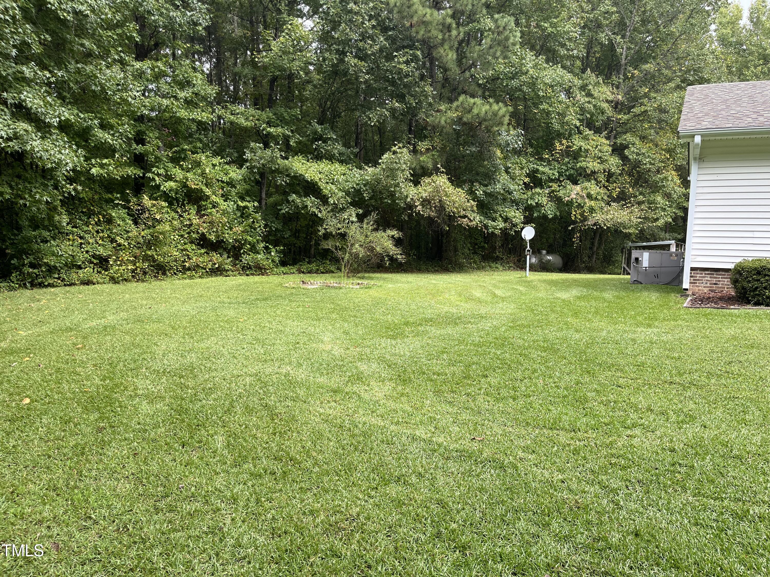 3143 Hester Road Creedmoor, NC 27522 - Photo 18 of 21 a view of a field of grass and trees