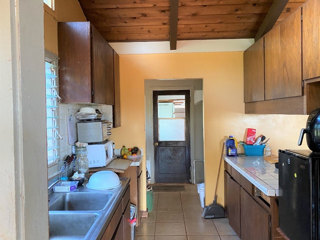 4825 Moi Road Hanapepe, HI 96716 - Photo 5 of 14 a kitchen with a sink and cabinets