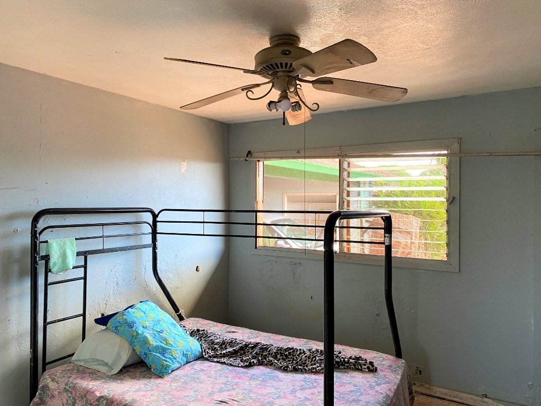 4825 Moi Road Hanapepe, HI 96716 - Photo 7 of 14 a living room with a bed furniture and a window