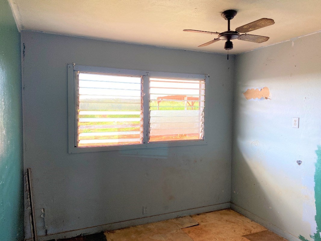 4825 Moi Road Hanapepe, HI 96716 - Photo 9 of 14 a view of room with a ceiling fan and window