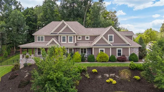 a front view of a house with a garden