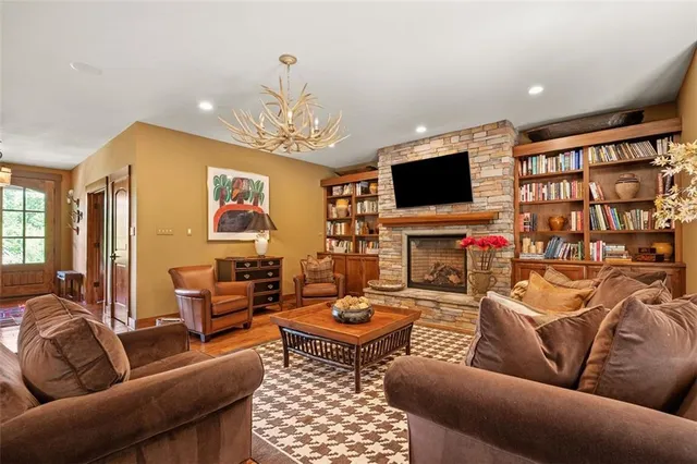 a living room with fireplace furniture and a flat screen tv