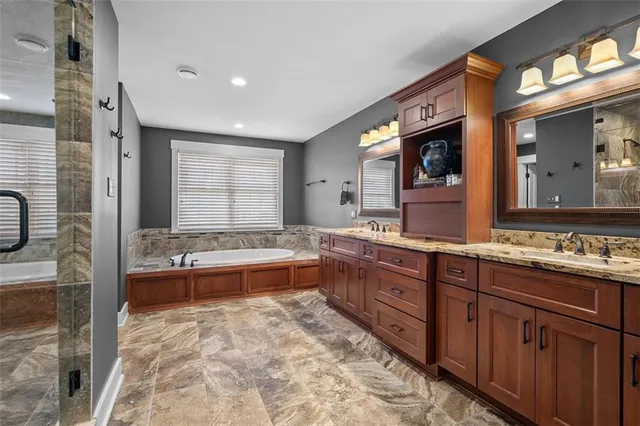 a large bathroom with a large tub and sink