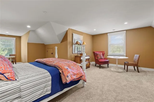 a spacious bedroom with a bed and a large window