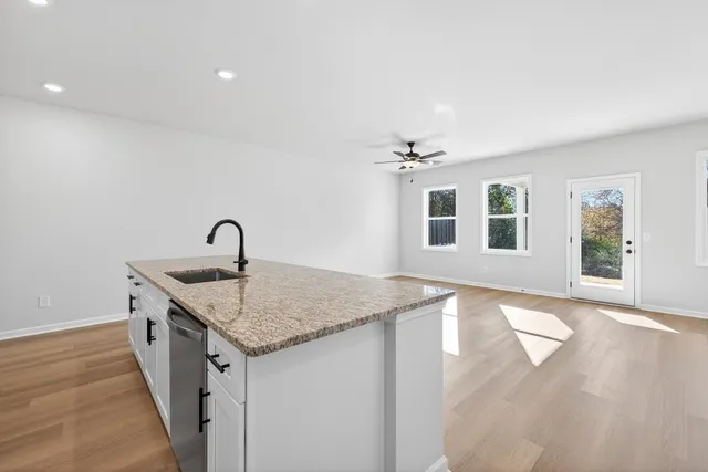 a kitchen with a sink stove and cabinets