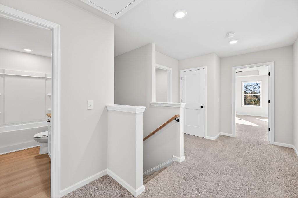 578 Madison Street, Unit 100 Commerce, GA 30529 - Photo 18 of 37 wooden floor in an empty room and a bathroom