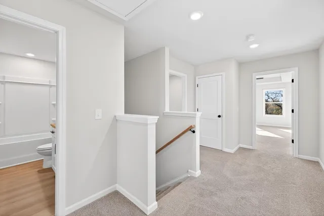 wooden floor in an empty room and a bathroom