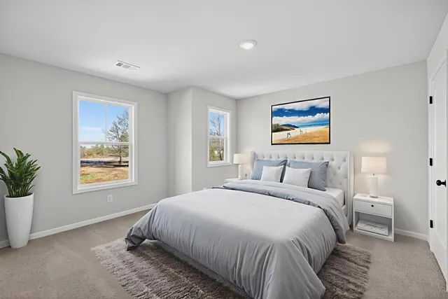 a bedroom with a large bed and a window