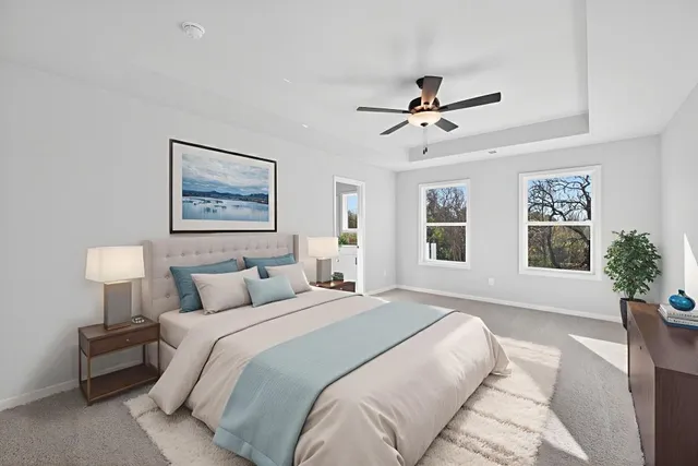 a bedroom with a large bed and a chandelier