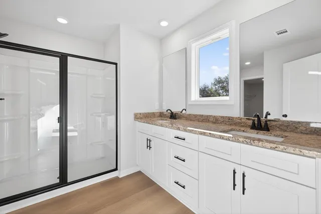 a bathroom with a granite countertop sink mirror and double