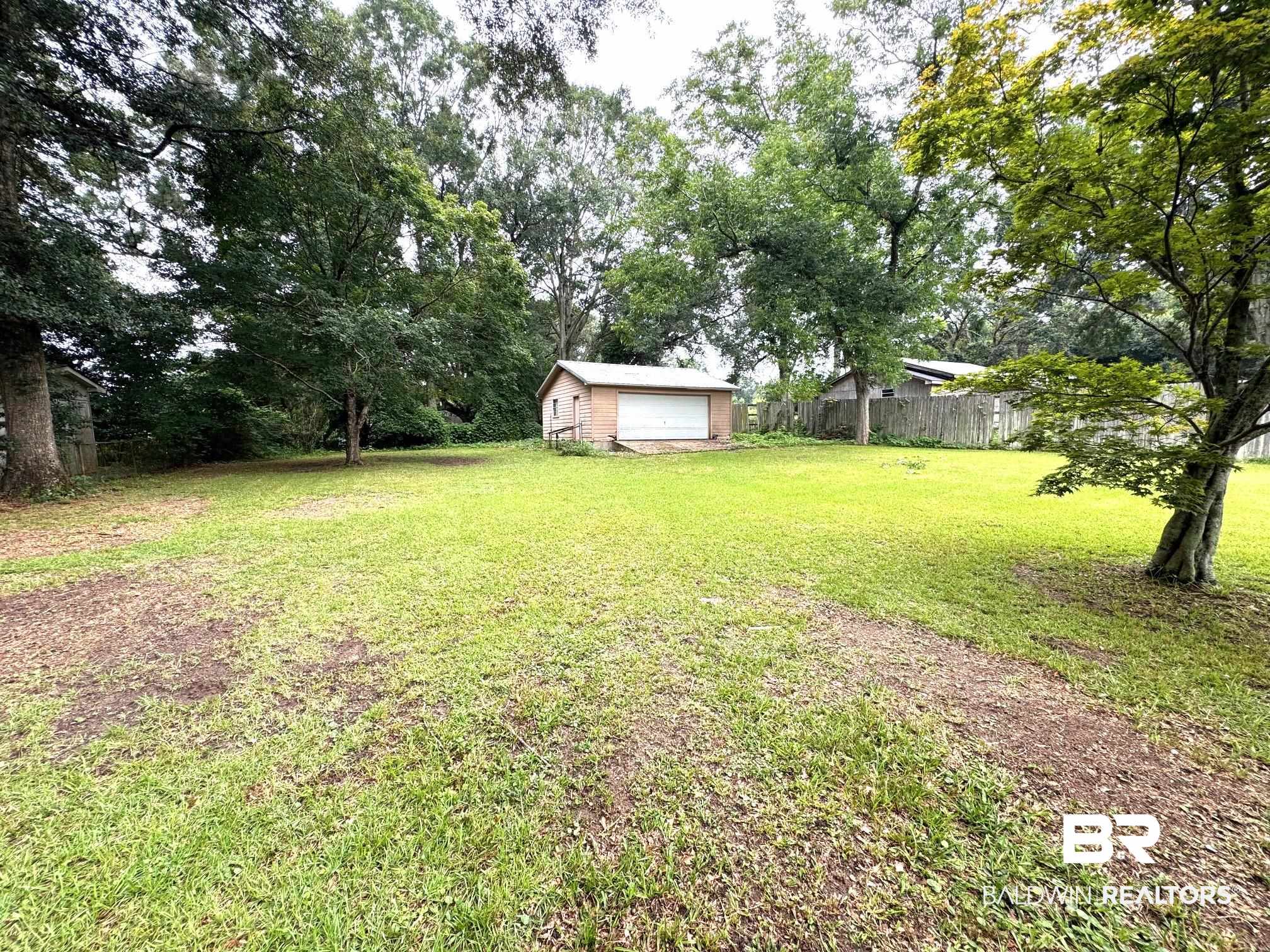 5198 Lancelot Drive Mobile, AL 36619 - Photo 24 of 30 View of yard featuring an outbuilding and a detached garage