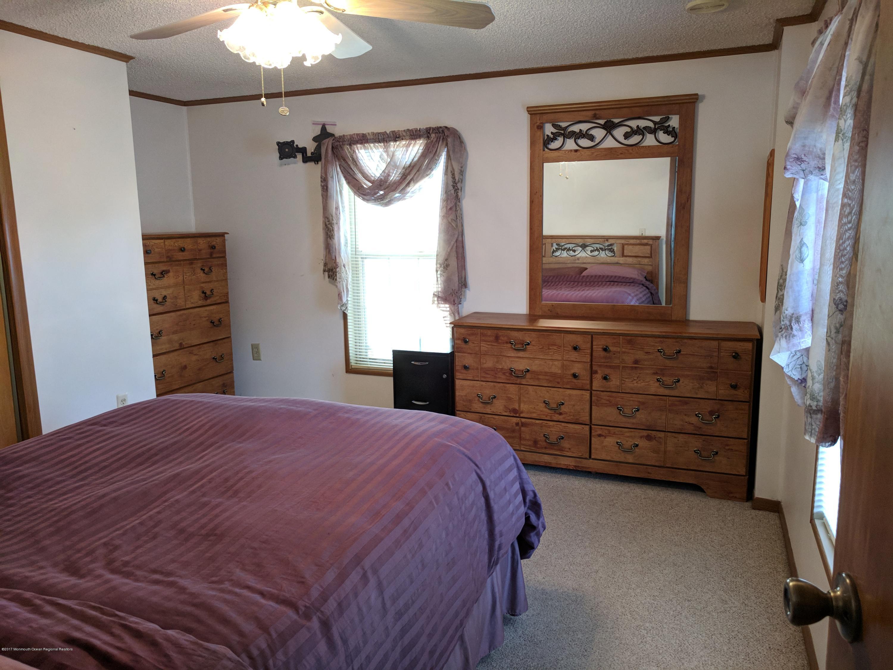 42 Ruffian Way Howell, NJ 07731 - Photo 7 of 7 a bedroom with a bed and a dresser