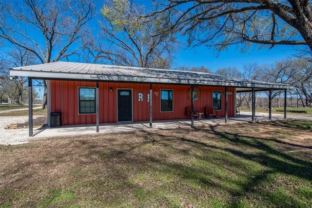 a view of a house with a yard and sitting area