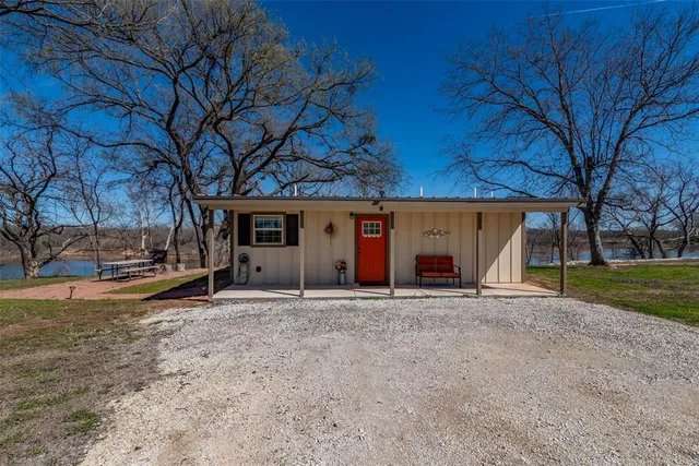 a kitchen with stainless steel appliances granite countertop a stove a sink dishwasher a microwave oven with a dining table and chairs