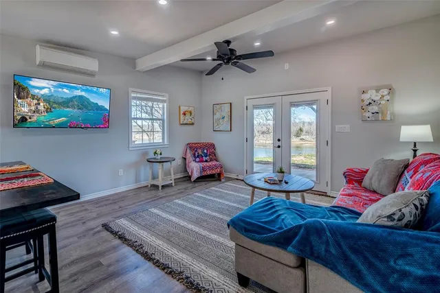 a living room with furniture and a floor to ceiling window