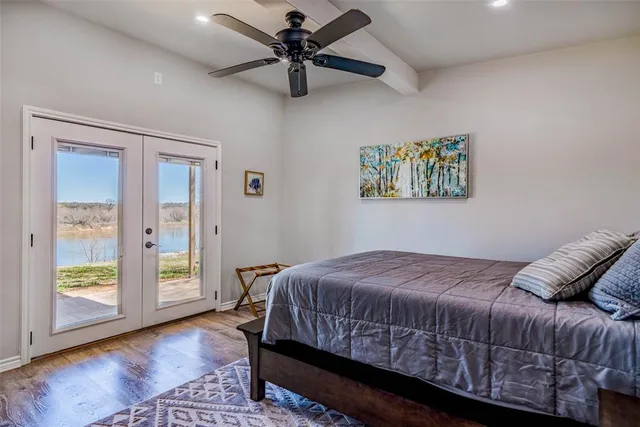 a bedroom with a bed and a mirror on the dresser