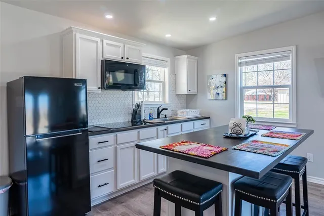 a bathroom with a toilet sink double vanity and mirror