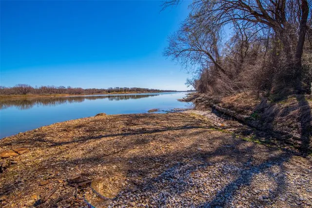 a view of a lake with houses in the back