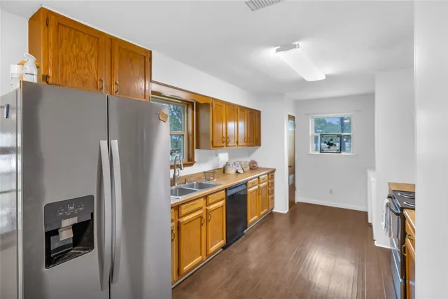 a kitchen with stainless steel appliances a refrigerator and a stove
