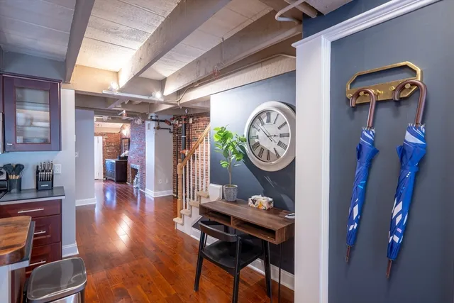 a view of a hallway with entryway wooden floor and dining room view