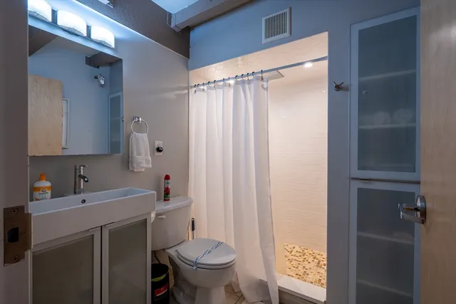 a bathroom with a sink toilet and shower