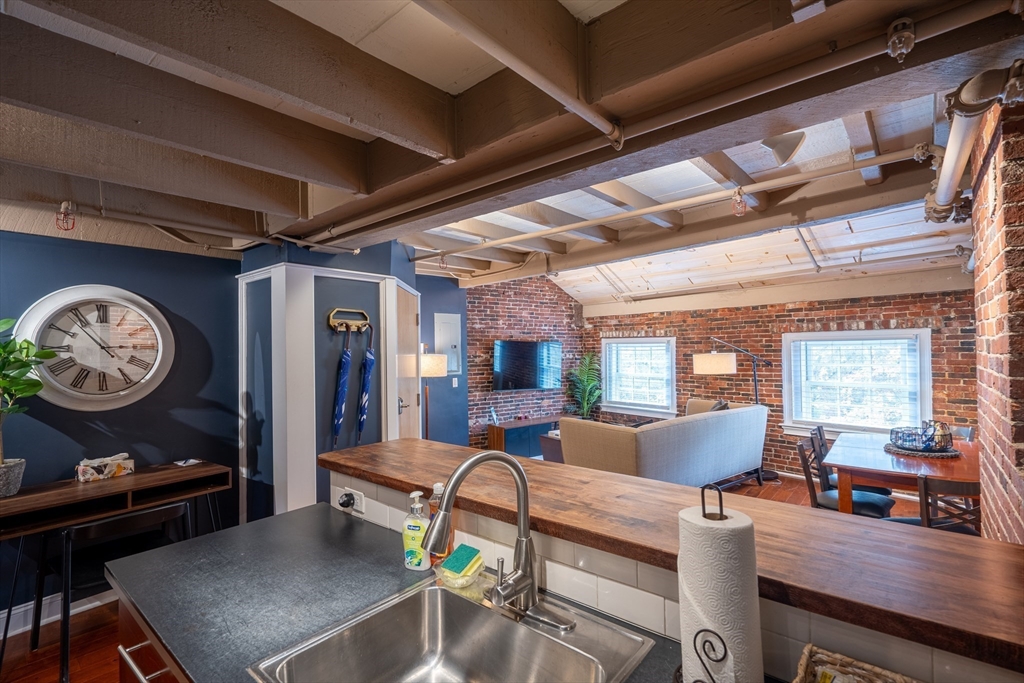 15 Union Street, Unit 3 Boston, MA 02108 - Photo 8 of 17 a living room with furniture a wooden floor and a large window