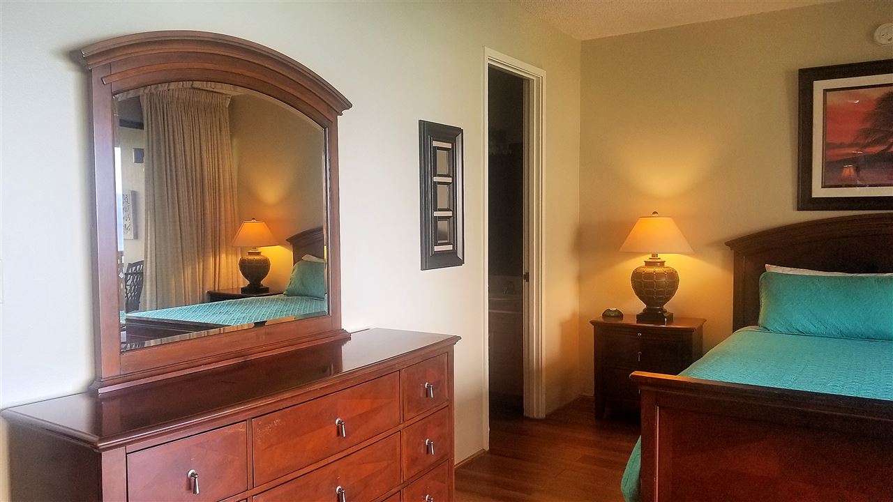 4299 Lower Honoapiilani Road, Unit 134 Lahaina, HI 96761 - Photo 11 of 29 a bedroom with a bed and wooden floor