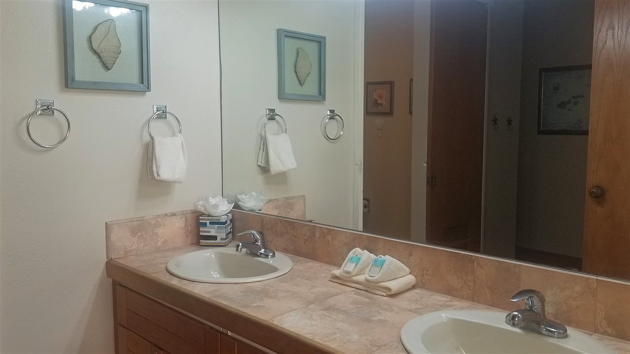 4299 Lower Honoapiilani Road, Unit 134 Lahaina, HI 96761 - Photo 13 of 29 a bathroom with a granite countertop sink and a mirror