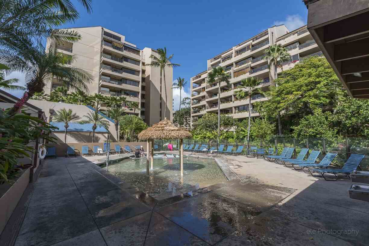 4299 Lower Honoapiilani Road, Unit 134 Lahaina, HI 96761 - Photo 24 of 29 a view of a tall building with a bench in front of it
