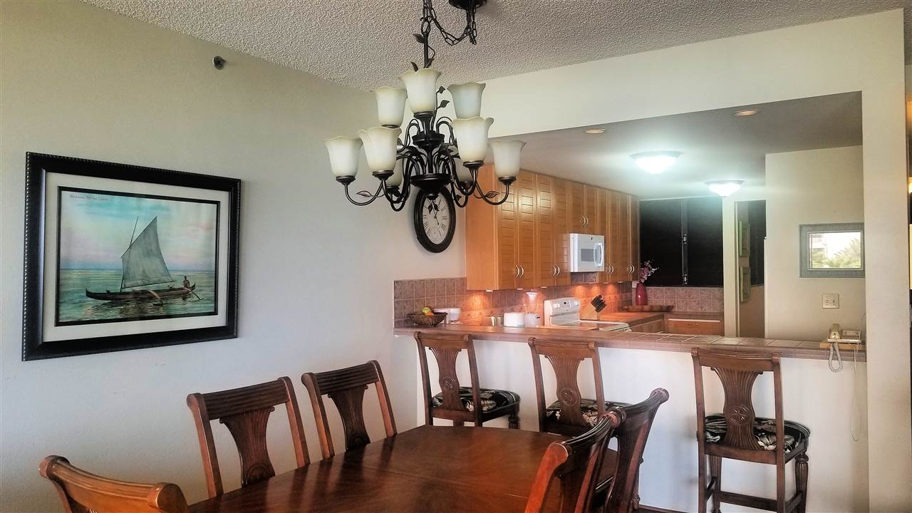 4299 Lower Honoapiilani Road, Unit 134 Lahaina, HI 96761 - Photo 3 of 29 a view of a dining room with furniture and a chandelier