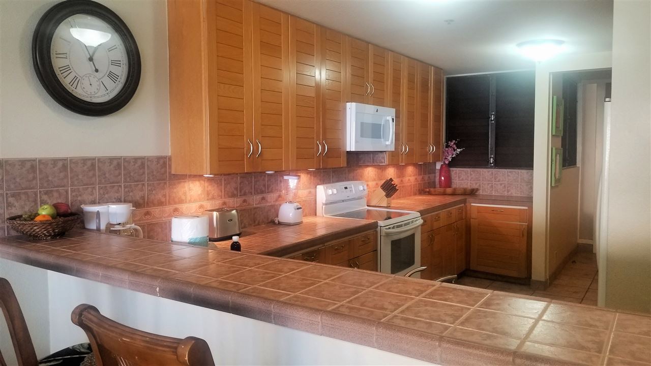 4299 Lower Honoapiilani Road, Unit 134 Lahaina, HI 96761 - Photo 5 of 29 a kitchen with a sink and a stove