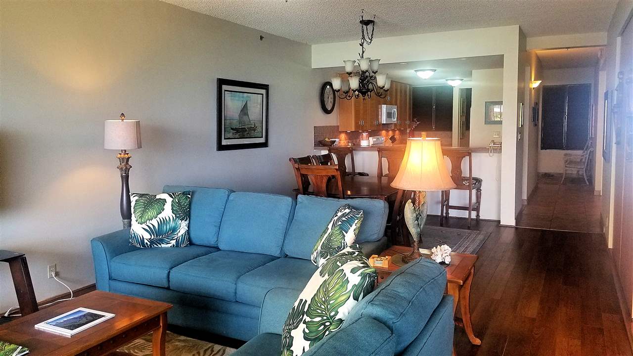 4299 Lower Honoapiilani Road, Unit 134 Lahaina, HI 96761 - Photo 8 of 29 a living room with furniture and a chandelier