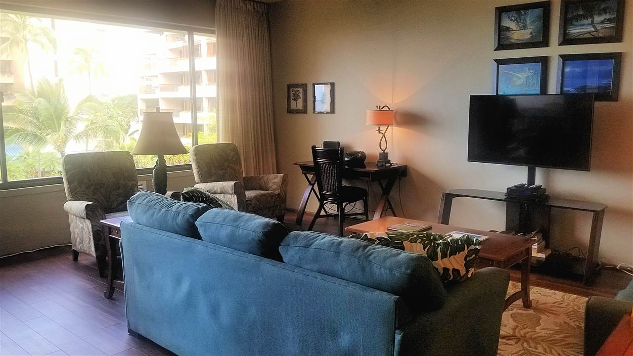 4299 Lower Honoapiilani Road, Unit 134 Lahaina, HI 96761 - Photo 9 of 29 a living room with furniture and a flat screen tv