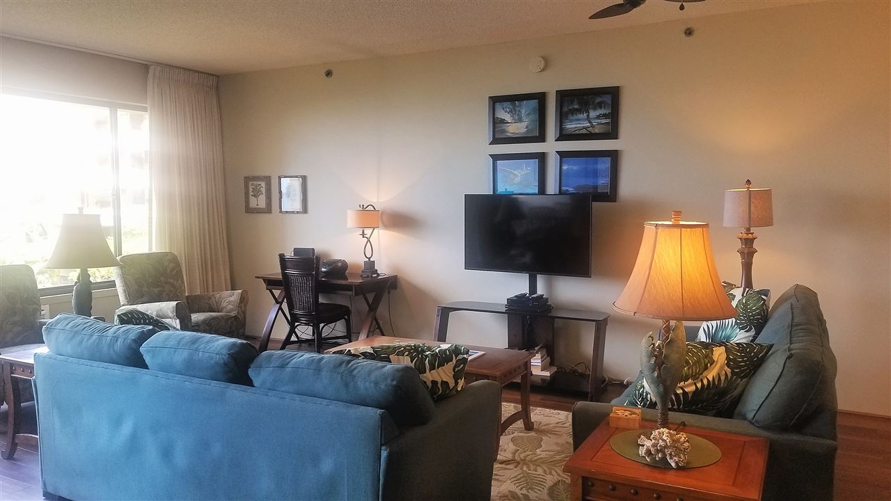 4299 Lower Honoapiilani Road, Unit 134 Lahaina, HI 96761 - Photo 10 of 29 a living room with furniture and a flat screen tv