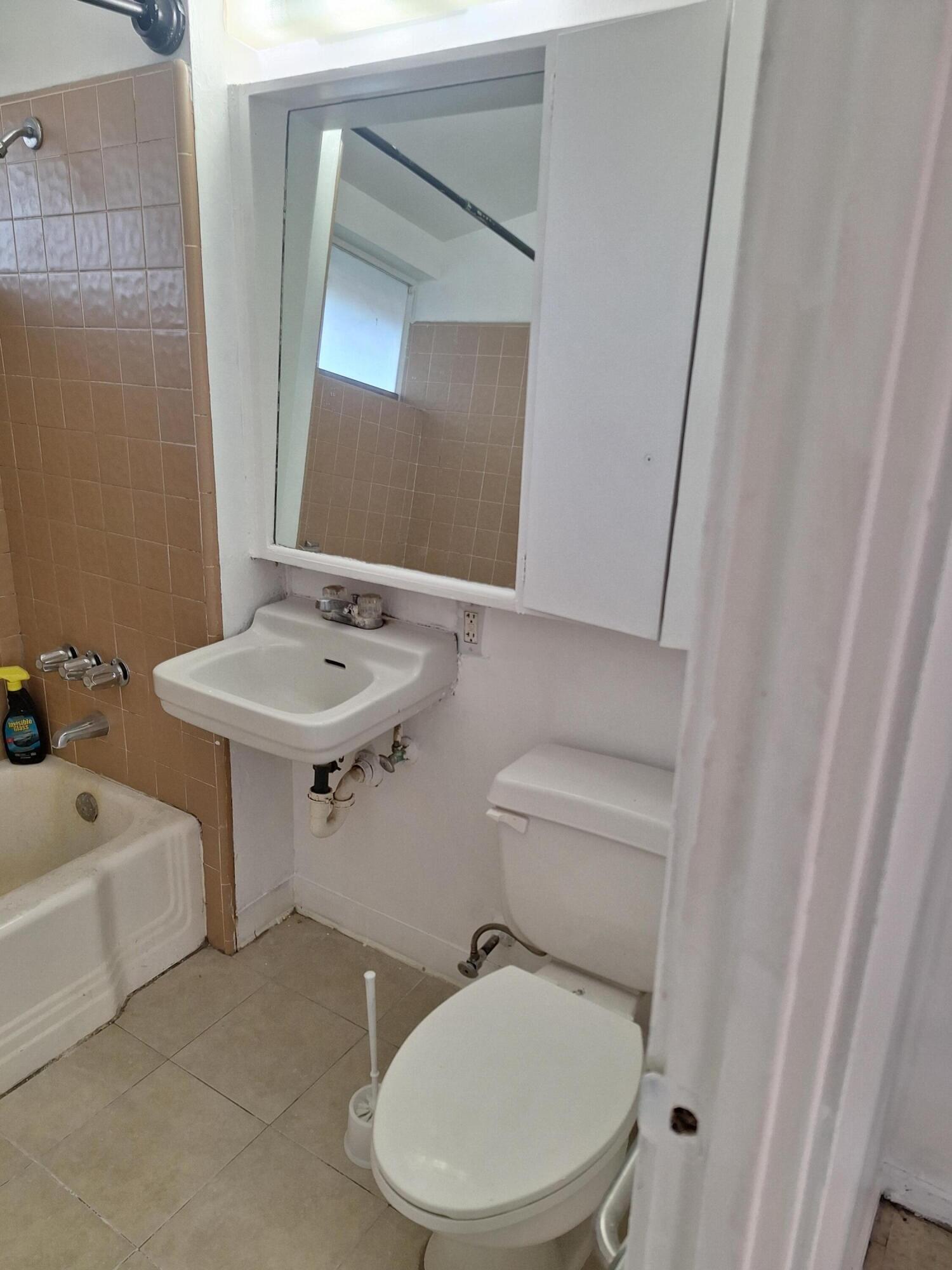 424 North Second Street Lompoc, CA 93436 - Photo 11 of 21 a bathroom with a toilet a sink and mirror
