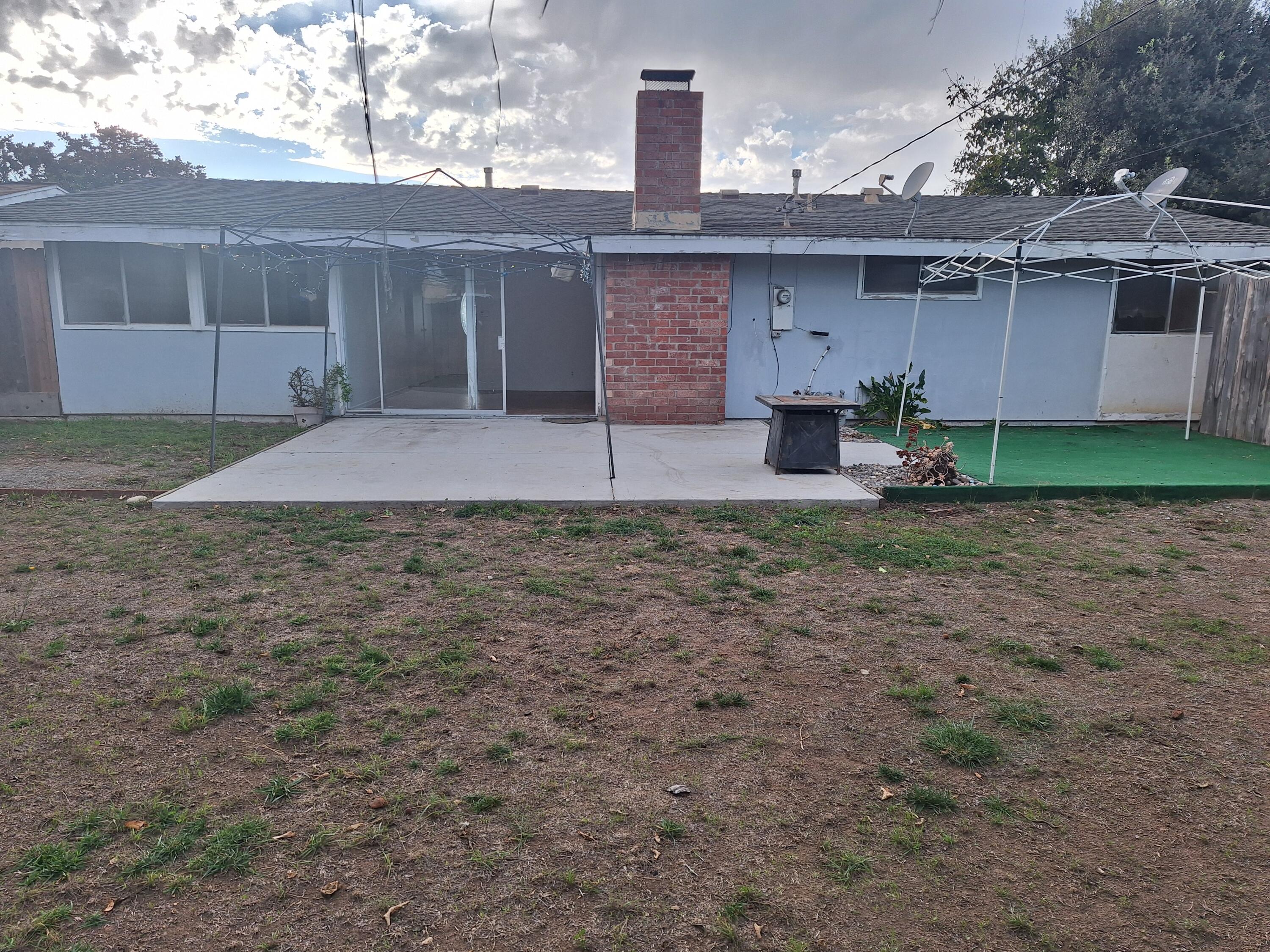 424 North Second Street Lompoc, CA 93436 - Photo 18 of 21 a view of a house with a yard and a large tree