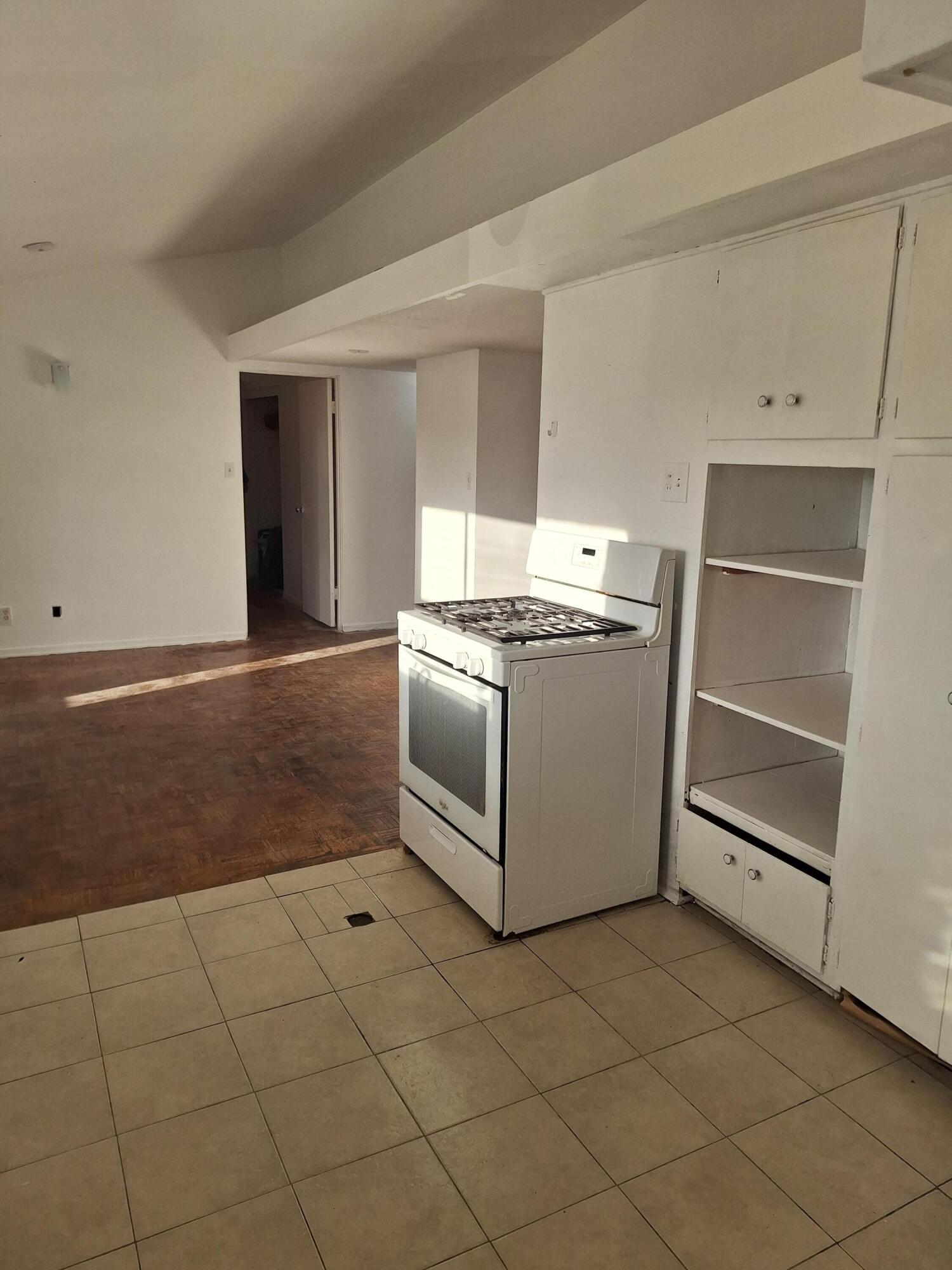 424 North Second Street Lompoc, CA 93436 - Photo 3 of 21 a kitchen with a stove and white cabinets