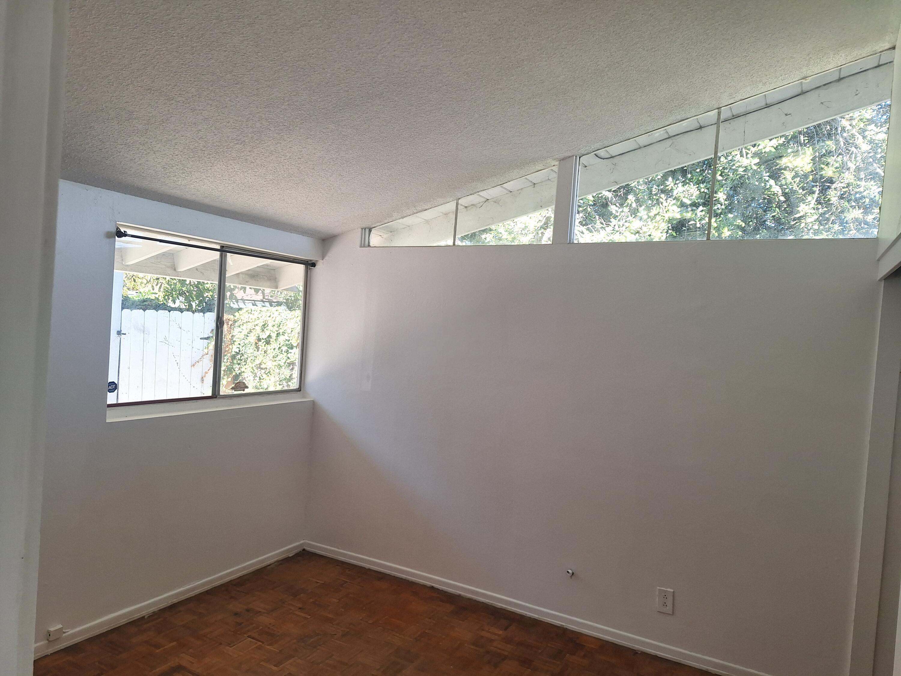 424 North Second Street Lompoc, CA 93436 - Photo 9 of 21 an empty room with wooden floor and windows