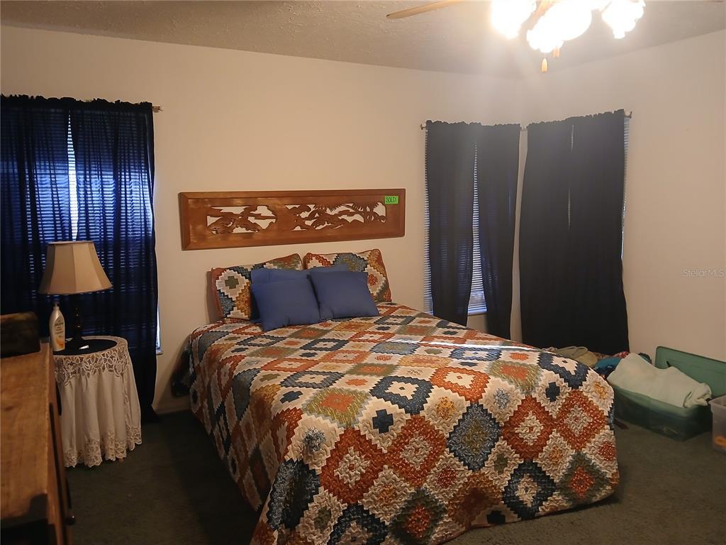 5497 West C Road Bushnell, FL 33513 - Photo 10 of 15 a bedroom with a bed and wooden floor