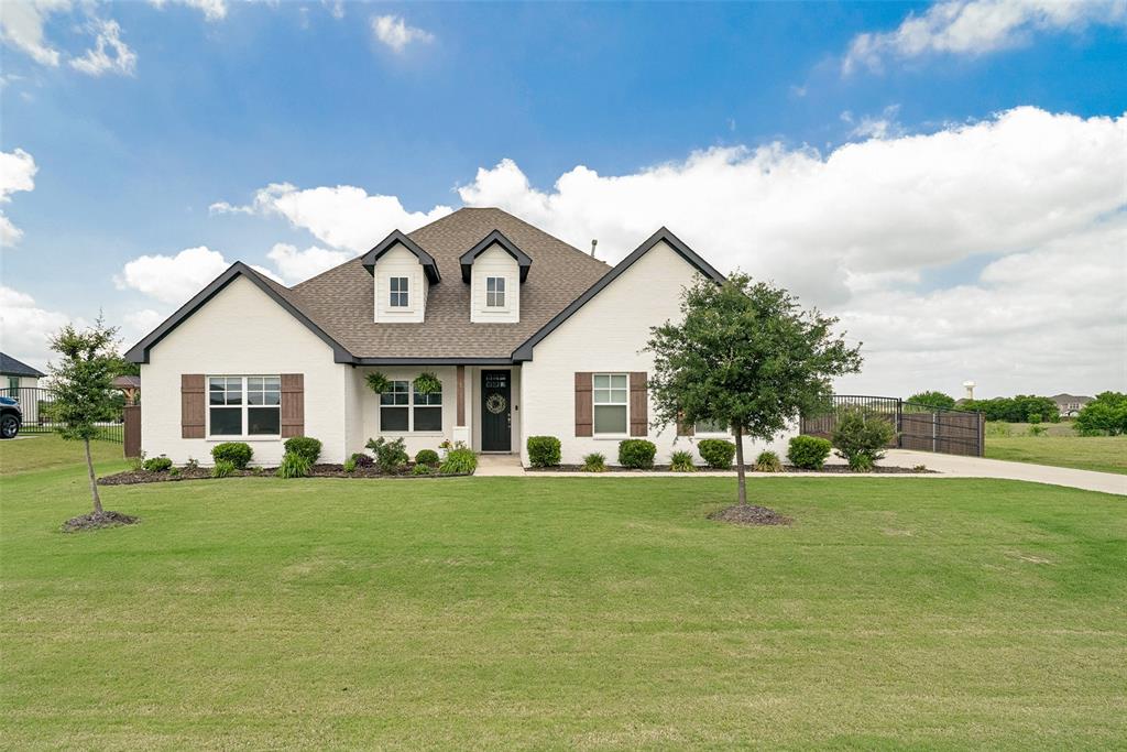 9424 Wildcat Ridge Godley, TX 76044 - Photo 1 of 25 a view of a white house with a big yard and large trees
