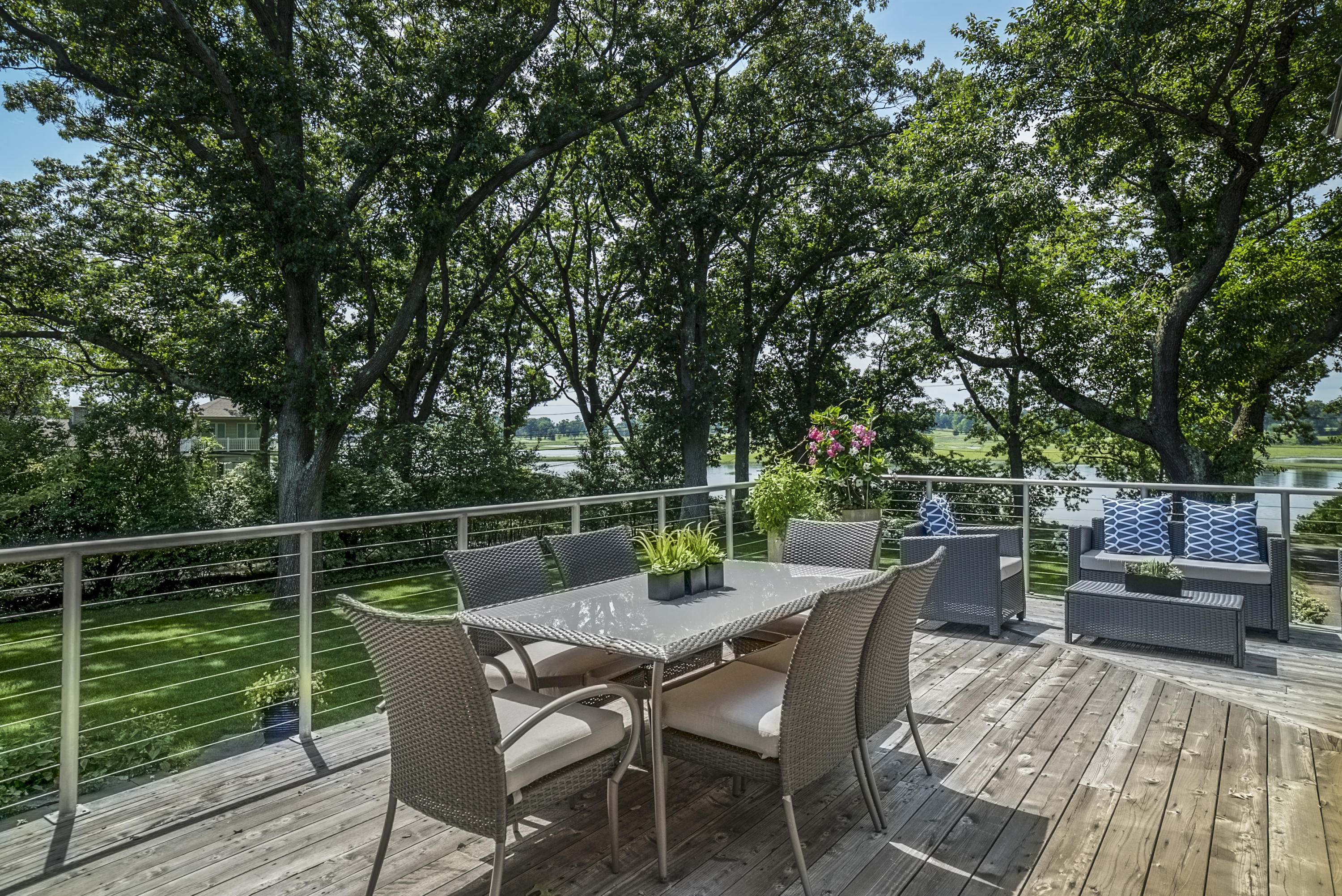 52 Shorehaven Road Westport, CT 06880 - Photo 18 of 37 a view of a roof deck with table and chairs and wooden floor