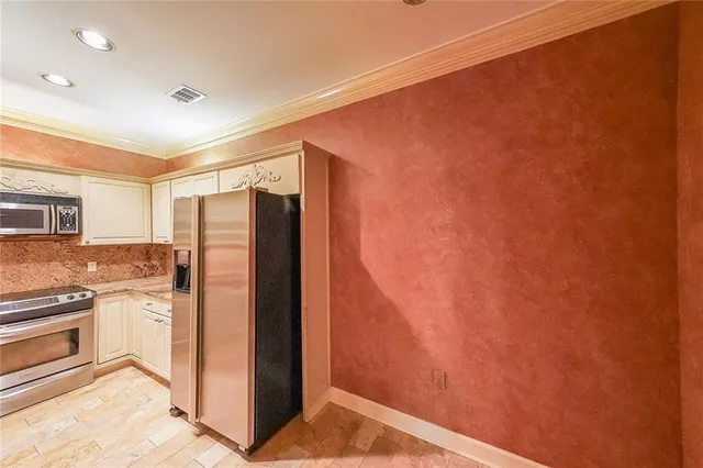 a kitchen with stainless steel appliances granite countertop a sink and cabinets