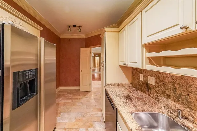 a view of an empty room with a window and a chandelier fan