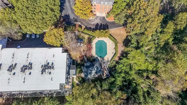 an aerial view of a house with a yard and garden