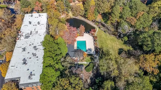 an aerial view of house with yard and swimming pool
