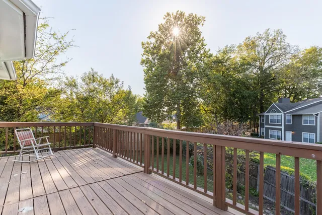a view of balcony with wooden floor and fence
