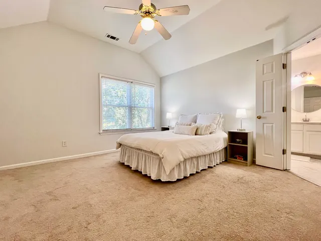 a spacious bedroom with a bed and a window